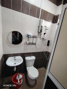 a bathroom with a toilet and a sink at D'RailHouse65 in Gemas +36 photos