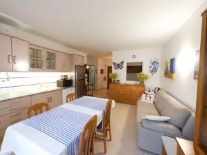 a kitchen and living room with a table and a couch at Dunas Sea and Sun Alvor in Alvor