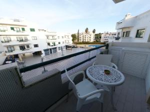 a balcony with a table and chairs and buildings at Dunas Sea and Sun Alvor in Alvor