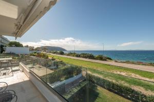 a view of the ocean from the balcony of a house at Saroné Villa in Anavyssos
