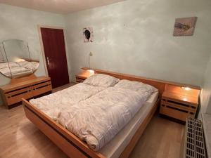 ein Schlafzimmer mit einem Bett und zwei Nachttischen in der Unterkunft Ferienhaus Riegler in Trattenbach