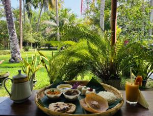 a tray of food sitting on a table with food at Coco Haven in Habaraduwa Central