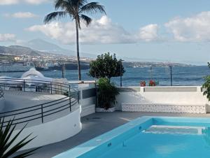 a swimming pool with a view of the ocean at Columbus Playa in Punta del Hidalgo