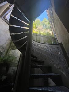 a spiral staircase in a building with a window at Le Duplex de la côte in Dinard +4 photos