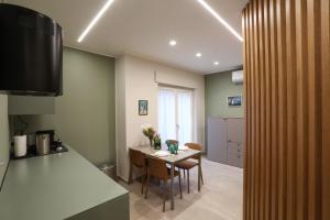 a kitchen and dining room with a table and chairs at Casetta Miranda in Naples +4 photos