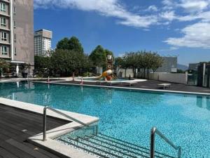 a large blue swimming pool in a city at Ipoh D Festivo Suites 6-10pax 10mins to Sunway Tambun by IWH in Ipoh