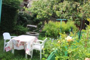 a table and two chairs in a garden at Les Hauts du Pâquier in Modane
