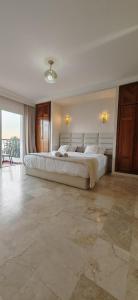 a large white bedroom with a large bed in it at marina1 in Agadir