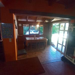 a dining room with a table and a window at El ceibo in Agua de Oro