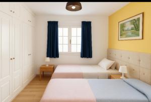 a bedroom with two beds and a window at Loma Estrella Ocean Suite Upper Arguineguín in Arguineguín +3 photos