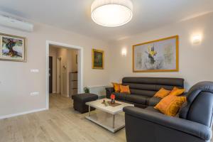 a living room with a couch and a table at Flores Luxury Suites-Rogoznica in Rogoznica +38 photos