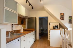 una cucina con mobili bianchi e un lavandino di Ferienwohnung Gut Lehmhof a Lehmrade 1 altra foto