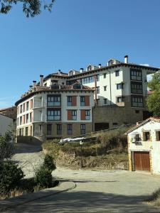 a large white building on top of a hill at el mirador de ona in Valdelinares