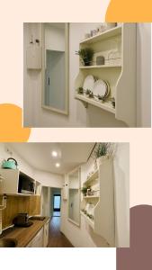 una cucina con armadi bianchi, lavandino e specchio di Modernes Apartment nahe Ludwigsburg & Stuttgart Netflix Parkplatz Optimale Lage a Ludwigsburg