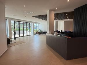a lobby of an office with a person standing at a counter at East Legon Loxwood House Condo with Gym & Pool in Accra +57 photos