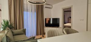 a living room with a couch and a television at Apartman La Campanella 2 in Vrnjci