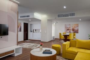 a living room with a yellow couch and a table at Tolip Family Park Hotel in Cairo