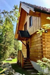 a log cabin with stairs leading to the door at Chata Vysoké Tatry in Stará Lesná