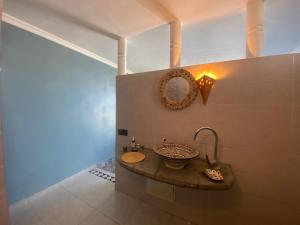 a bathroom with a sink and a mirror on the wall at Charming room with balcony and ocean view in Essaouira