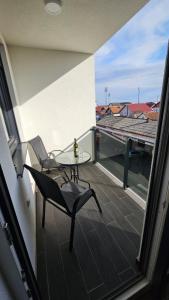 a balcony with a table and chairs on a roof at Stan na dan Jović in Modriča