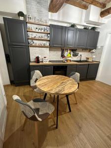 a kitchen with a wooden table and chairs in it at Residenza la Mandorla in Perugia