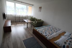 1 dormitorio con cama, sofá y mesa en Apartment Igor, en Lúčky