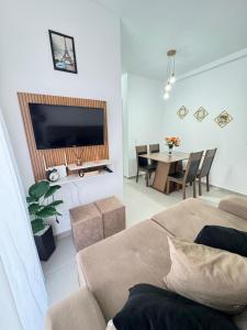 a living room with a couch and a table at Cozy apartment near the airport in São José dos Pinhais +18 photos