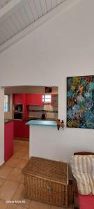 a kitchen with red cabinets and a counter top at Villa Hibiscus in Sainte-Anne