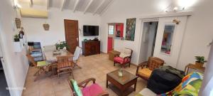 a living room with a couch and a table at Villa Hibiscus in Sainte-Anne
