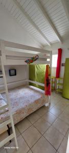 a bedroom with a bunk bed in a room at Villa Hibiscus in Sainte-Anne +8 photos