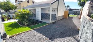 a view of a house with a yard at Villa Hibiscus in Sainte-Anne