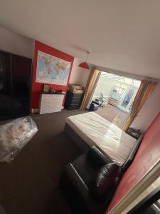 a living room with a bed and a large window at spacious King bed 30FT Room in Kenton +1 photo