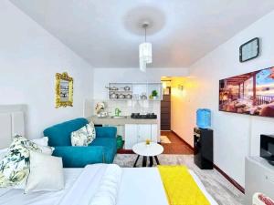 a living room with a blue couch and a table at Travel Nest in Nairobi