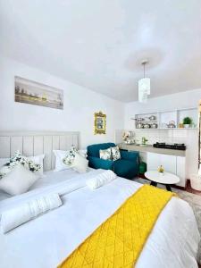 a bedroom with a large bed and a blue couch at Travel Nest in Nairobi