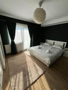a bedroom with a white bed and a rug at Apartament The Office-Scorțarilor Cluj in Cluj-Napoca