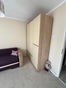 a living room with a couch and a cabinet at Apartament The Office-Scorțarilor Cluj in Cluj-Napoca +4 photos