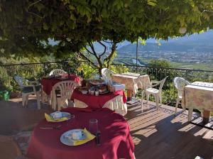 a table with plates of food on top of a deck at B&B Le tre chiavi in Isera
