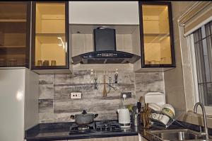 a kitchen with a sink and a stove top oven at 3M-Z Lekki Luxury Shortlet Duplex Apartment in Mama +18 photos