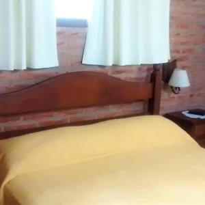 a bedroom with a bed and a window with white curtains at okin 11 flores in Costa del Este