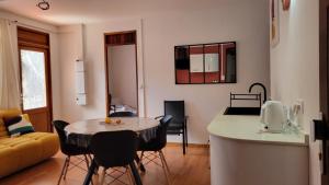 a kitchen and a living room with a table and chairs at Osvalley Résidence in Basse-Terre