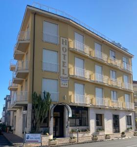 a yellow building with a sign that says hotel at Hotel SoleMare in Diano Marina