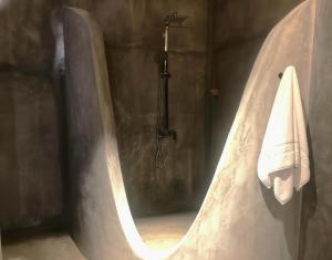 a bathroom with a bath tub with a towel at Yohan Eco Lodge Udawalawe in Udawalawe