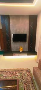 a living room with a flat screen tv on a wall at GK appartments in Bengaluru +2 photos