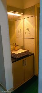 a bathroom with a sink and a mirror at GK appartments in Bengaluru