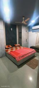 a bedroom with a large bed with a red comforter at GK appartments in Bengaluru