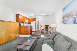 a living room with a couch and a table at Alpenglow Lodge Large Studio with Dedicated Work Space by MVA in Whistler