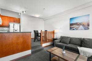 a living room with a couch and a table at Alpenglow Lodge Large Studio with Dedicated Work Space by MVA in Whistler