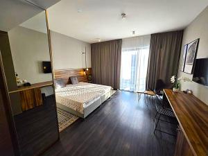 a bedroom with a bed and a large window at Woda i góry - studio z widokiem na góry i zalew in Sosnówka