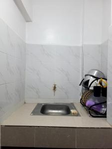 a kitchen counter with a sink in the corner at Serene63 Studios Kenol,Muranga in Gitura