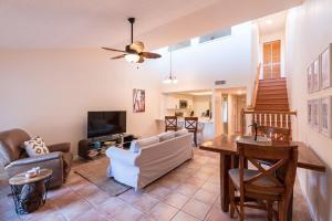a living room with a couch and a table at Beachside Townhome Just Steps from Cocoa Beach in Cocoa Beach